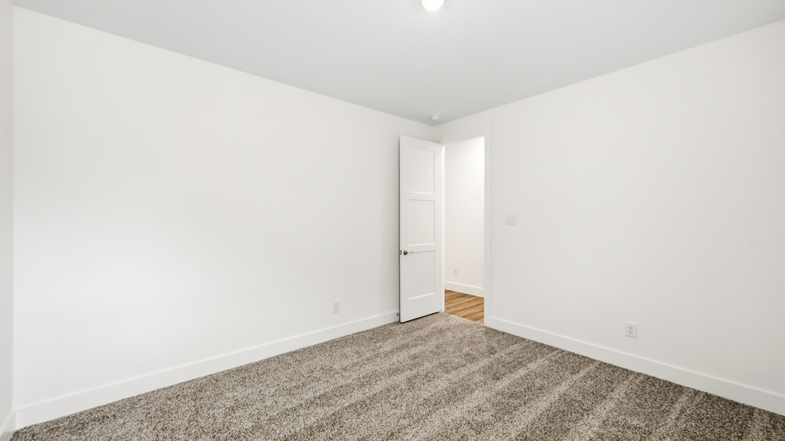 Secondary bedroom with carpet flooring