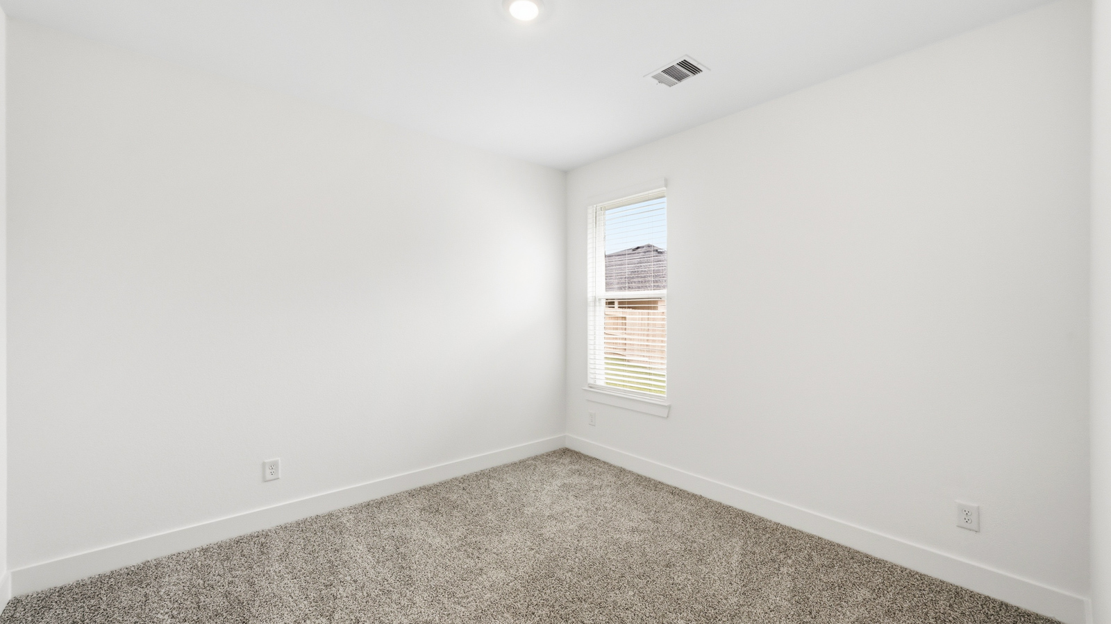 Secondary bedroom with carpet flooring