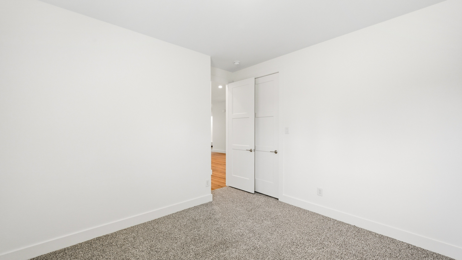 Secondary bedroom with carpet flooring