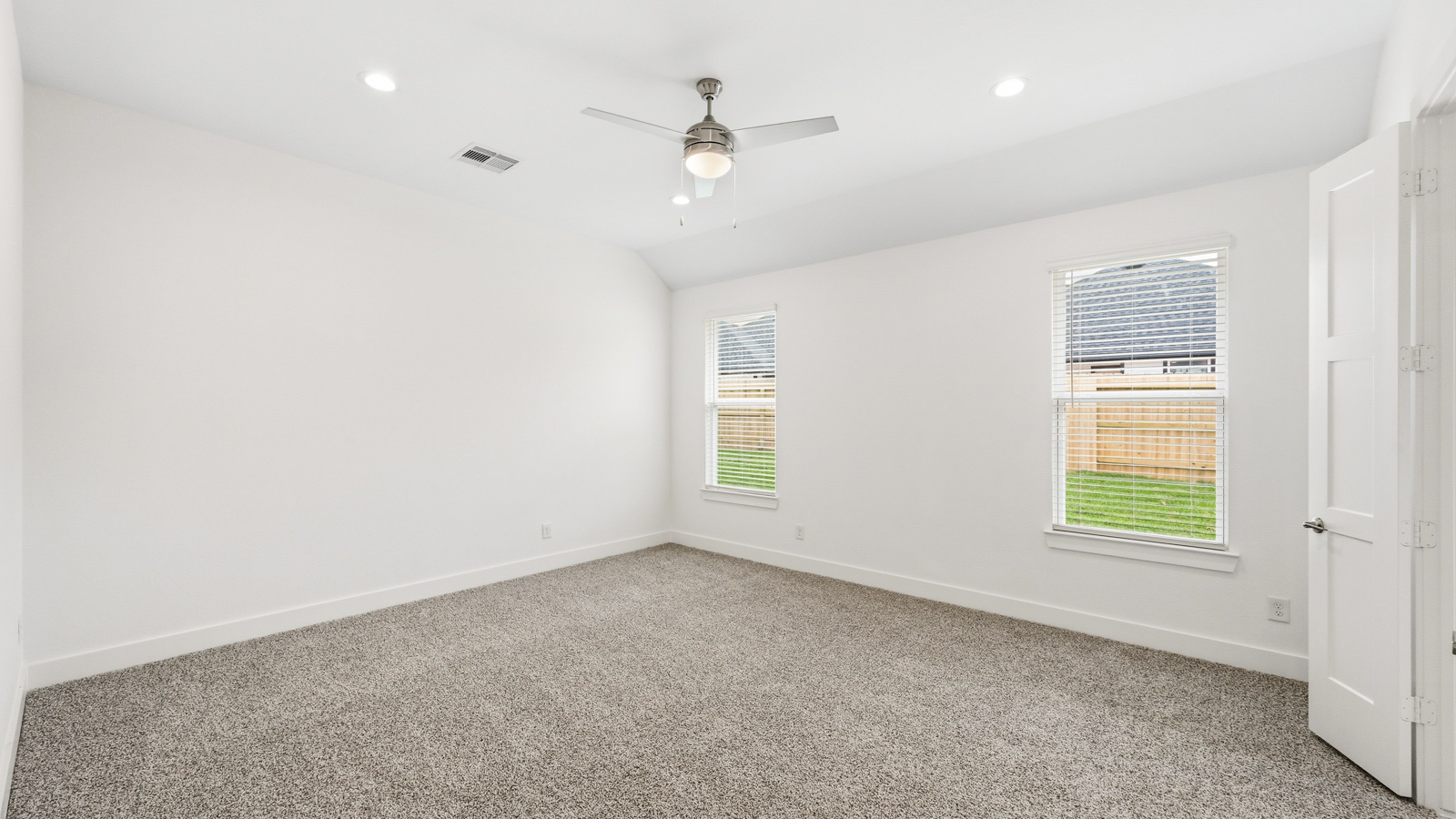 Secondary bedroom with carpet flooring