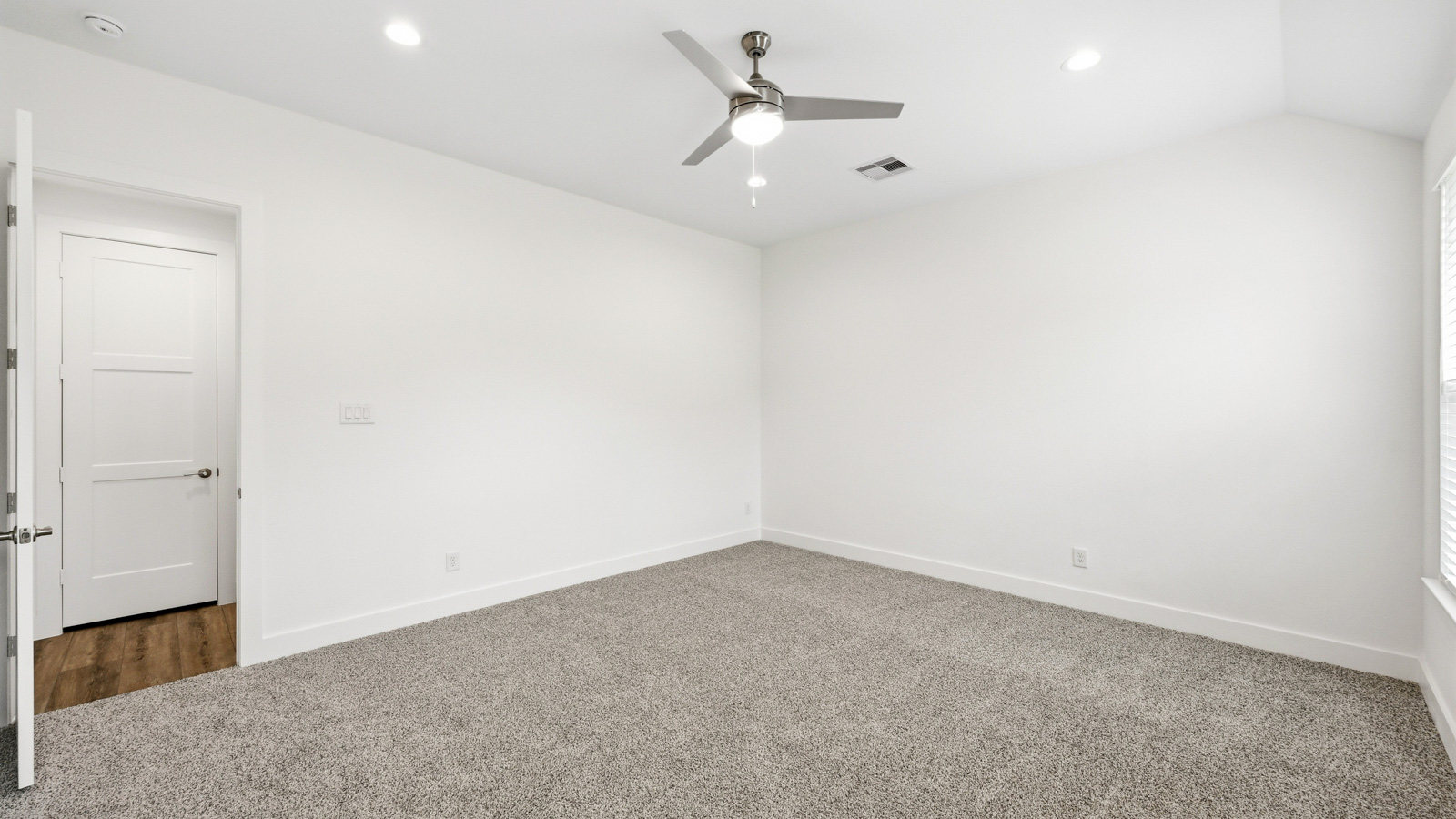Secondary bedroom with carpet flooring