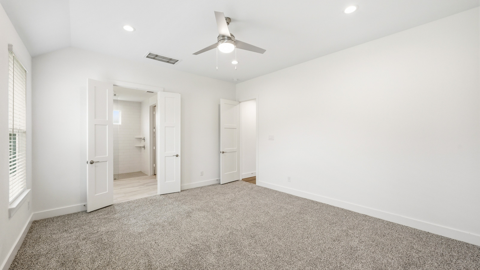 Primary bedroom with carpet flooring