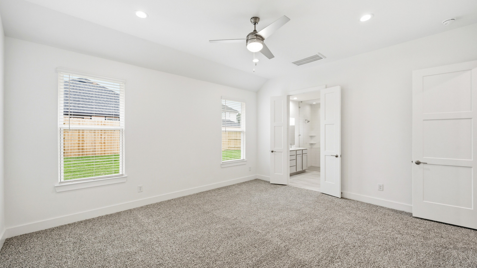 Primary bedroom with carpet flooring