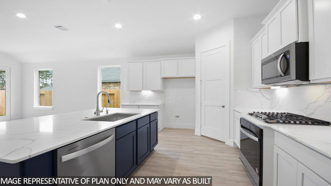 Kitchen with an island and vinyl floor