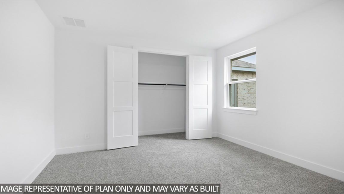 Secondary bedroom with carpet flooring