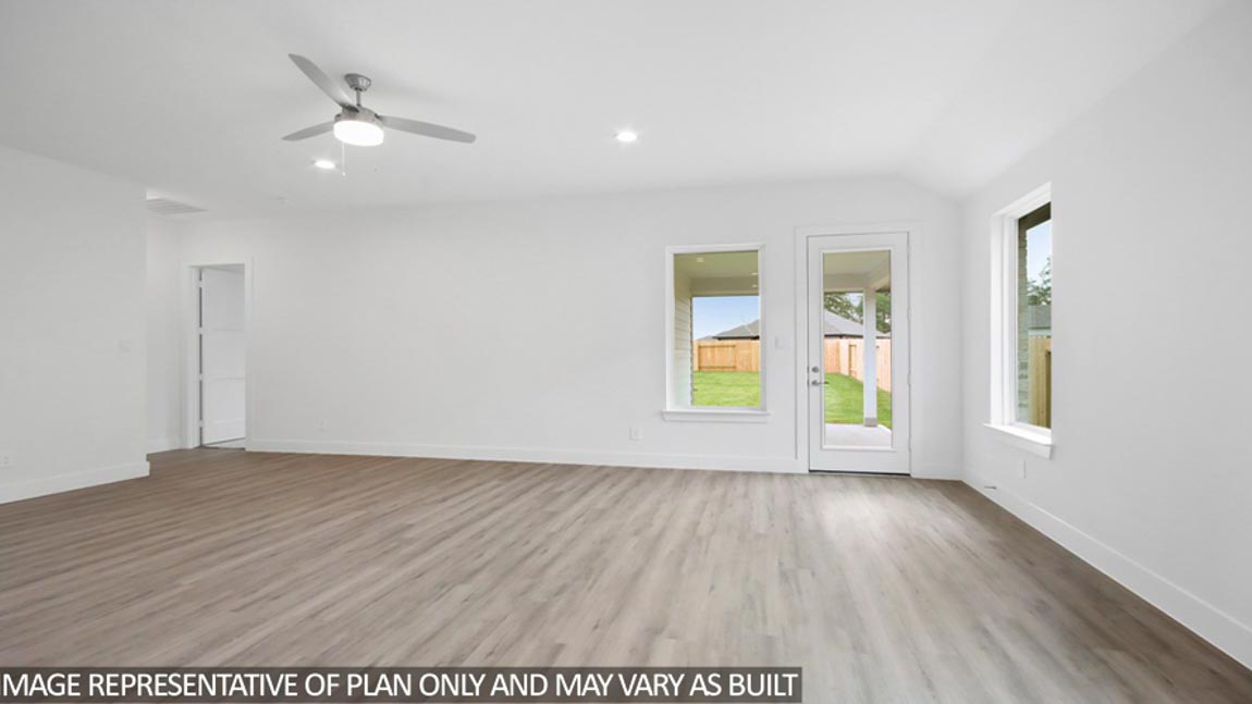 Spacious living area with vinyl flooring
