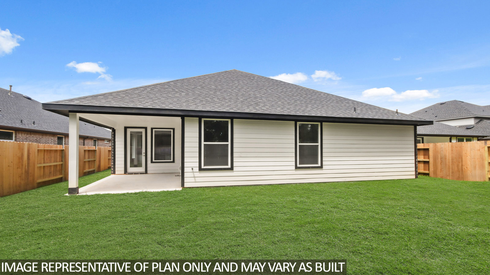 Landscaped backyard with a covered patio.