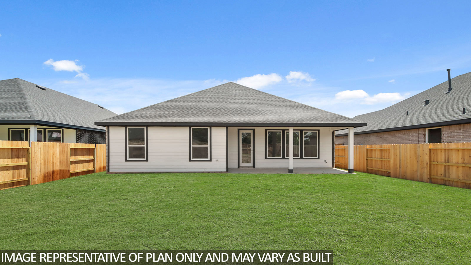 Landscaped backyard with a covered patio.