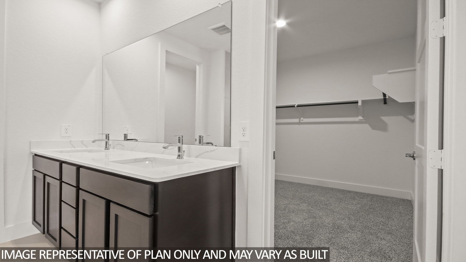 Primary bathroom with vinyl flooring and double sink.