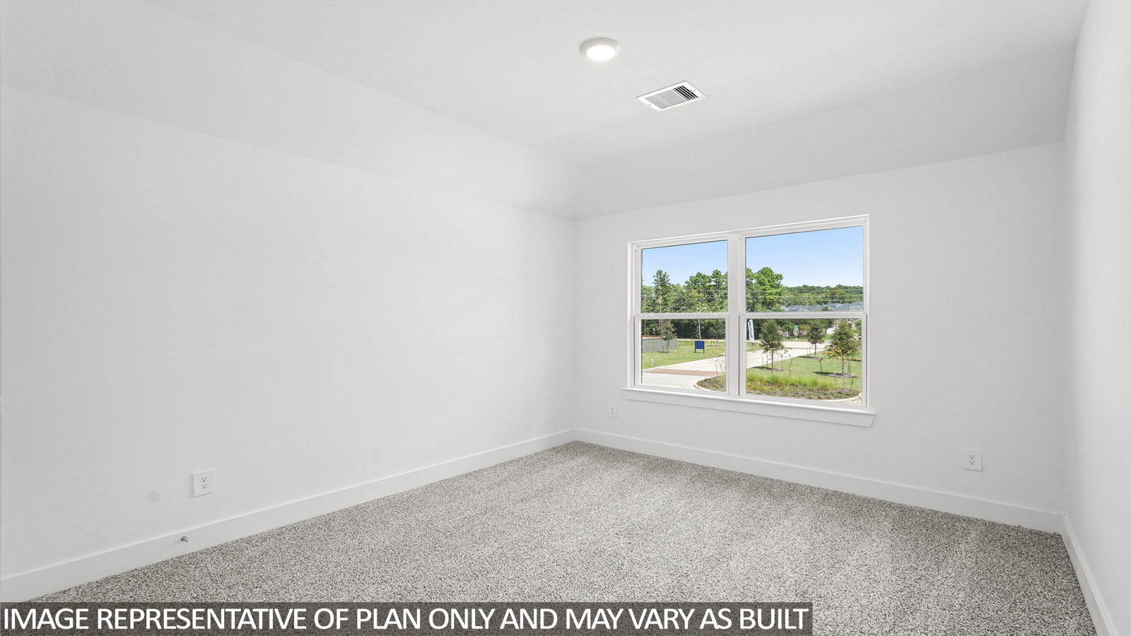 Secondary bedroom with carpet flooring