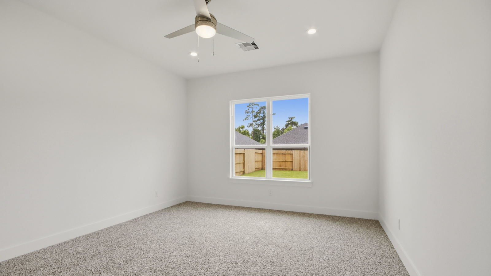 Large Primary bedroom with shag carpet flooring and bright window