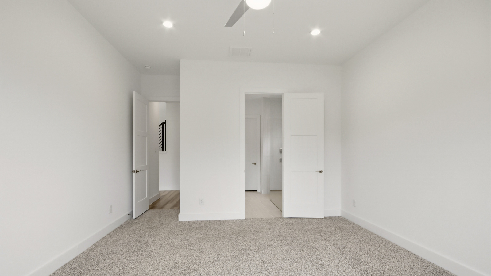 Large Primary bedroom with shag carpet flooring and bright window