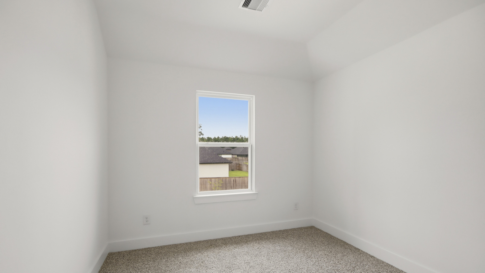 Secondary bedroom with shag carpet flooring and bright window