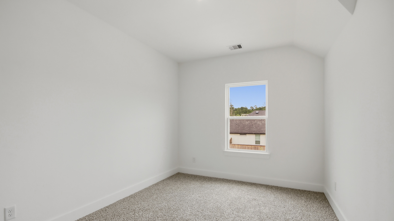 Secondary bedroom with shag carpet flooring and bright window