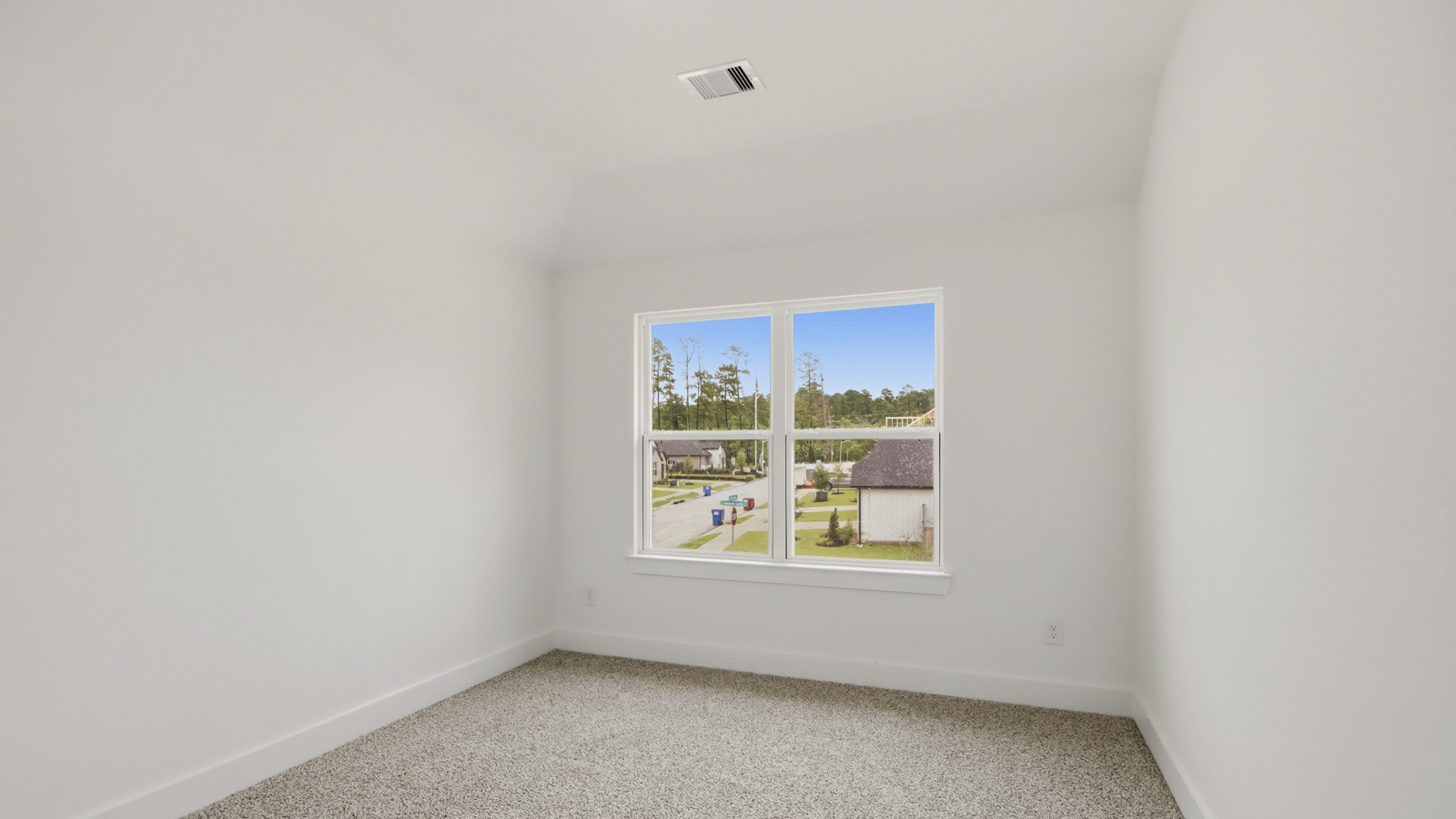 Secondary bedroom with shag carpet flooring and bright window