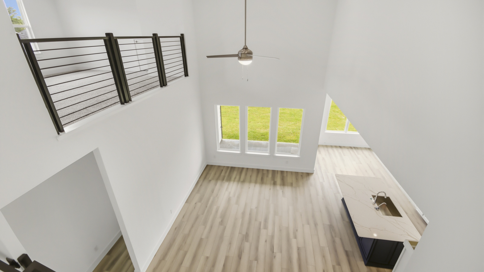 Second story game room with carpet flooring with bright windows in this multi functional space in Conroe TX