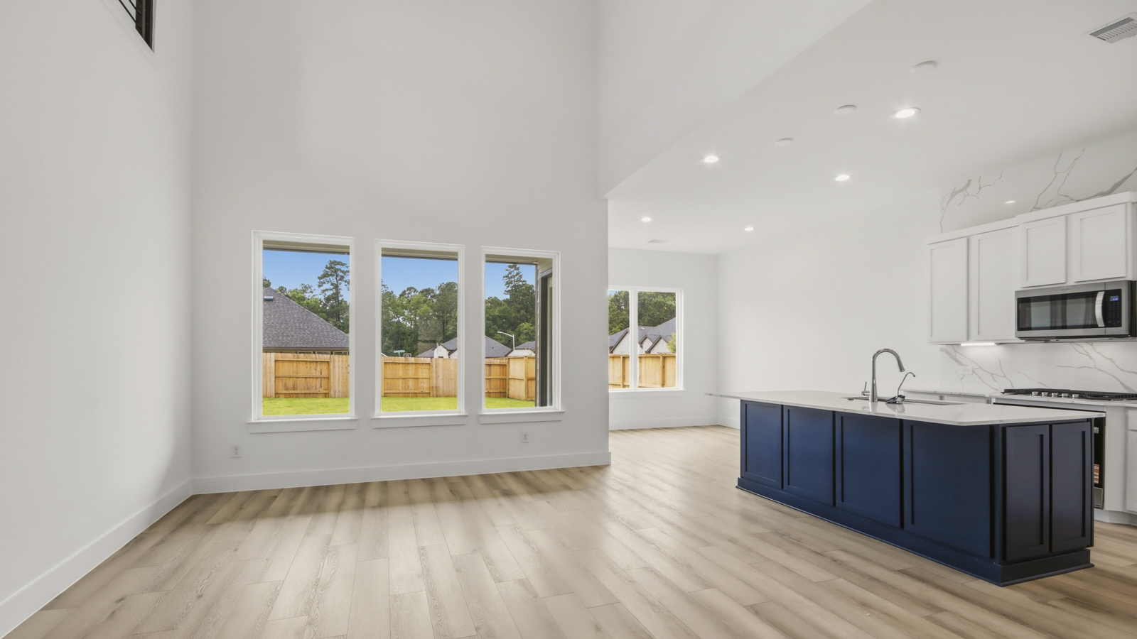 Kitchen with quartz countertops and marden hardware and an island and vinyl floor