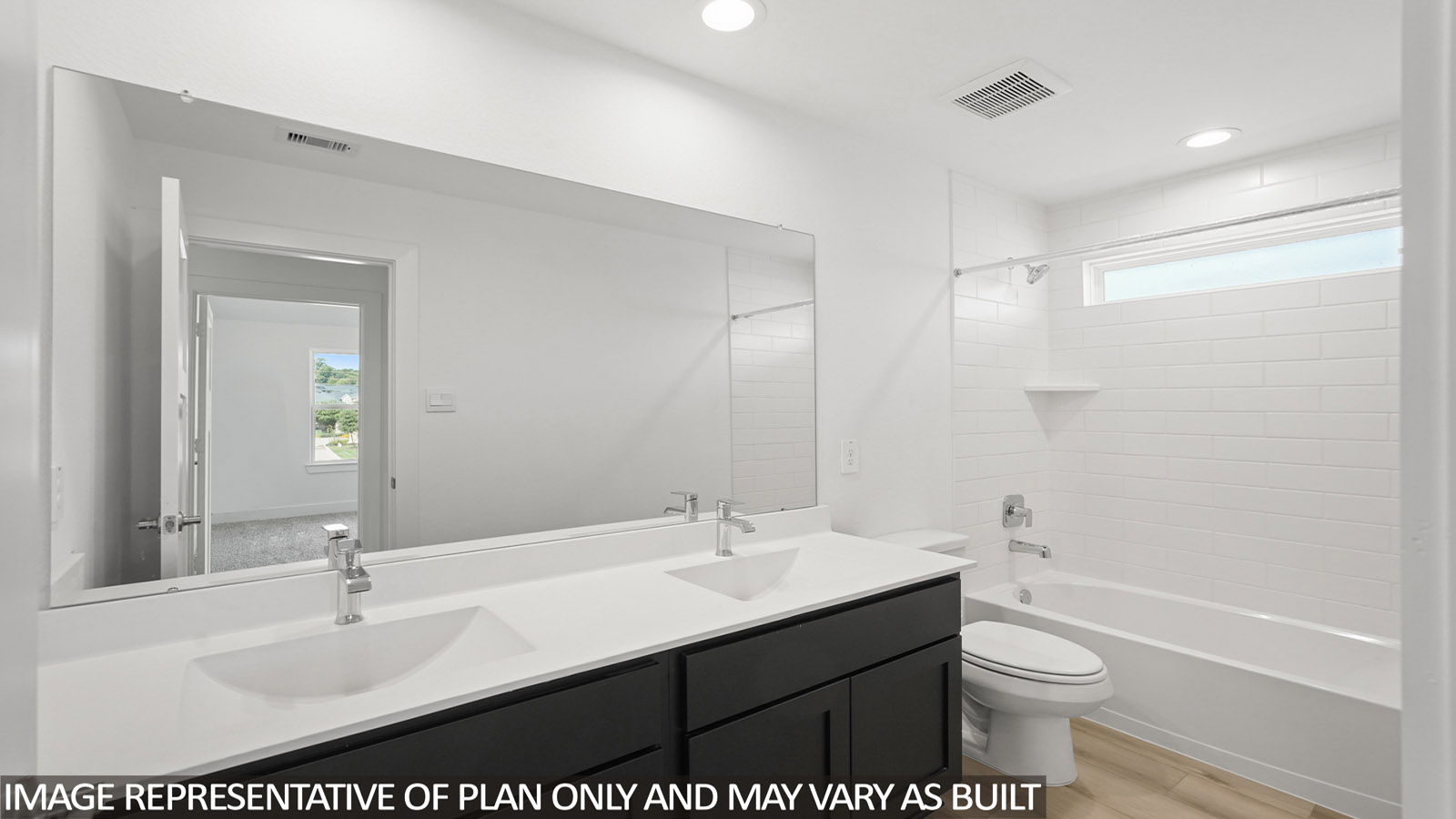 Family full bathroom featuring a stylish vanity, mirror, polished fixtures, cabinets, and tub-shower combo