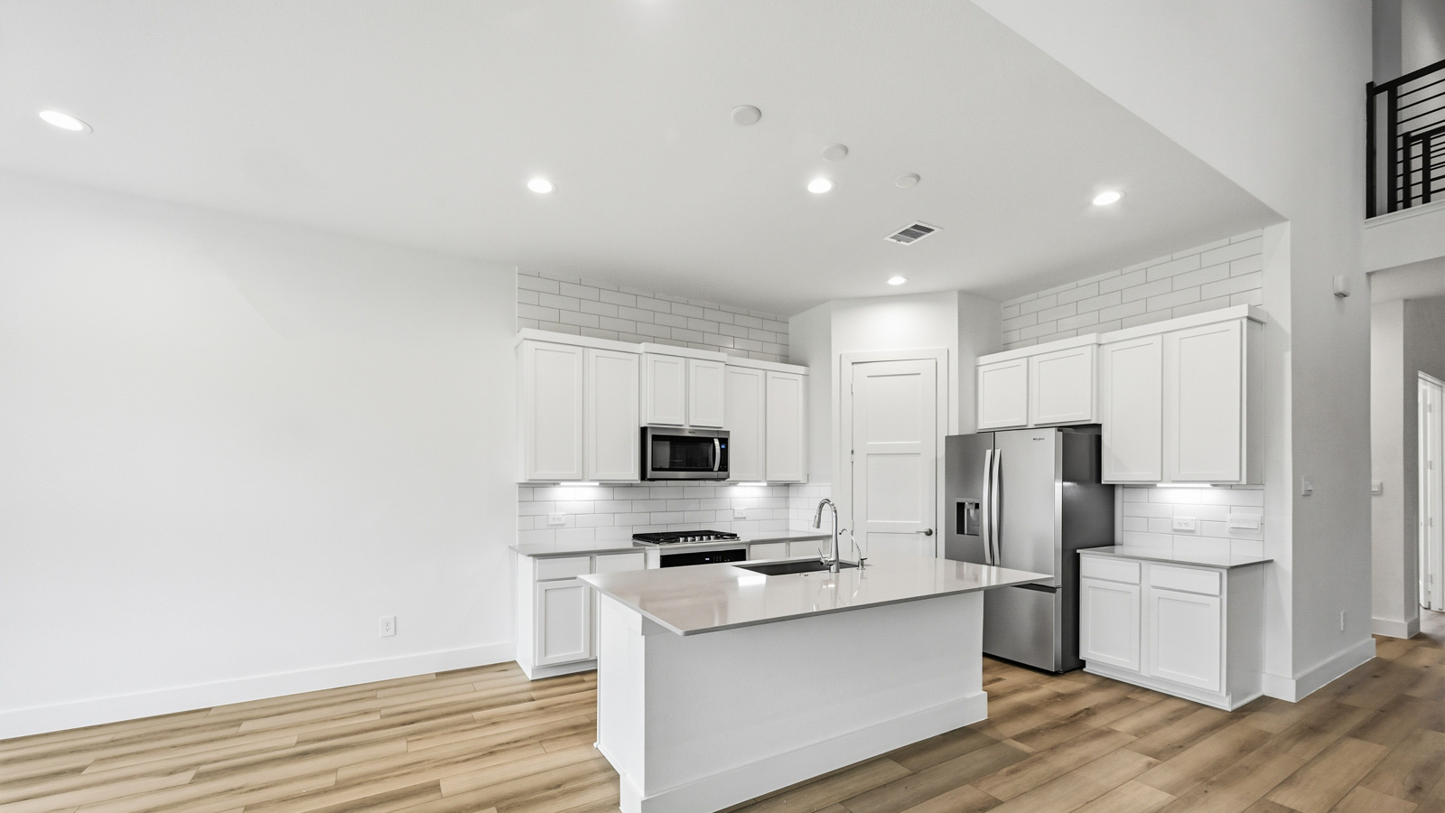 Kitchen with an island and vinyl floor