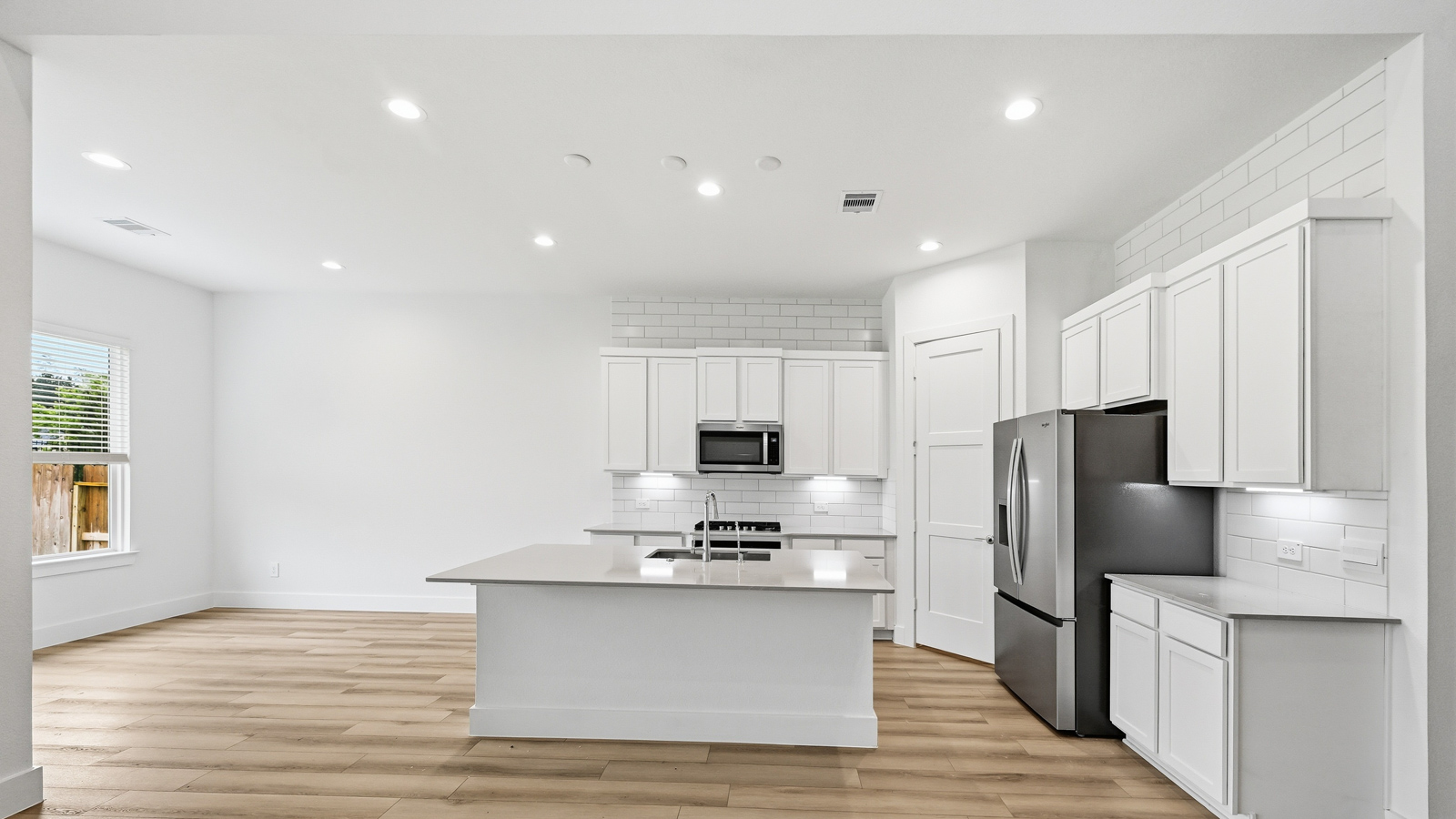 Kitchen with an island and vinyl floor