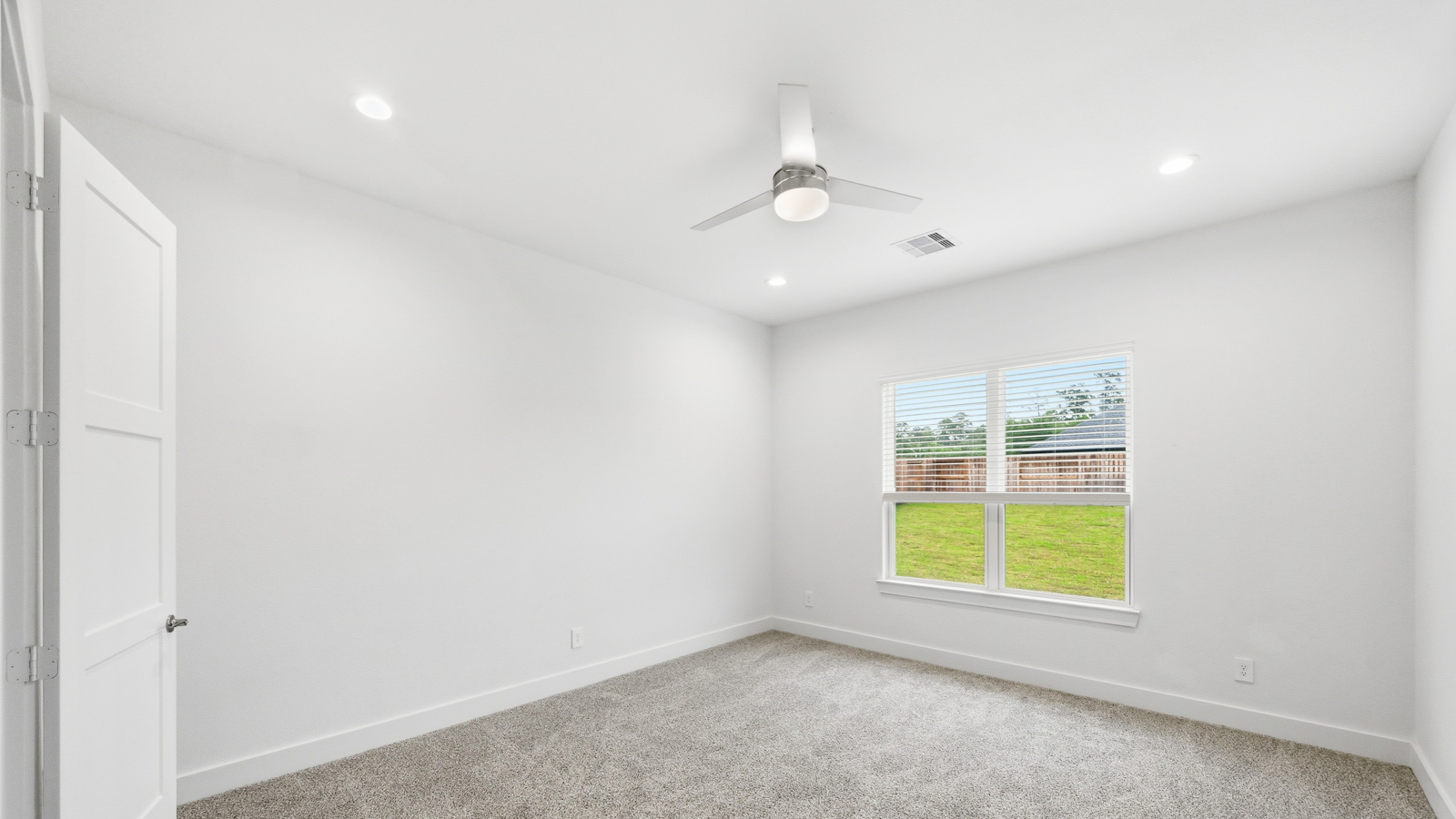 Primary bedroom with carpet flooring
