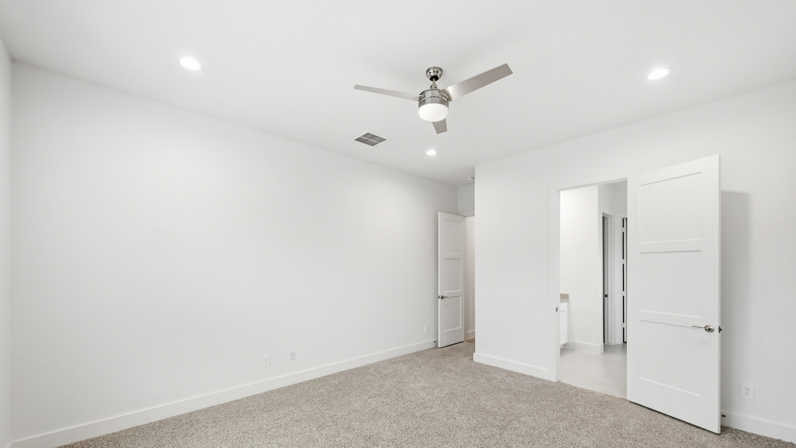 Primary bedroom with carpet flooring