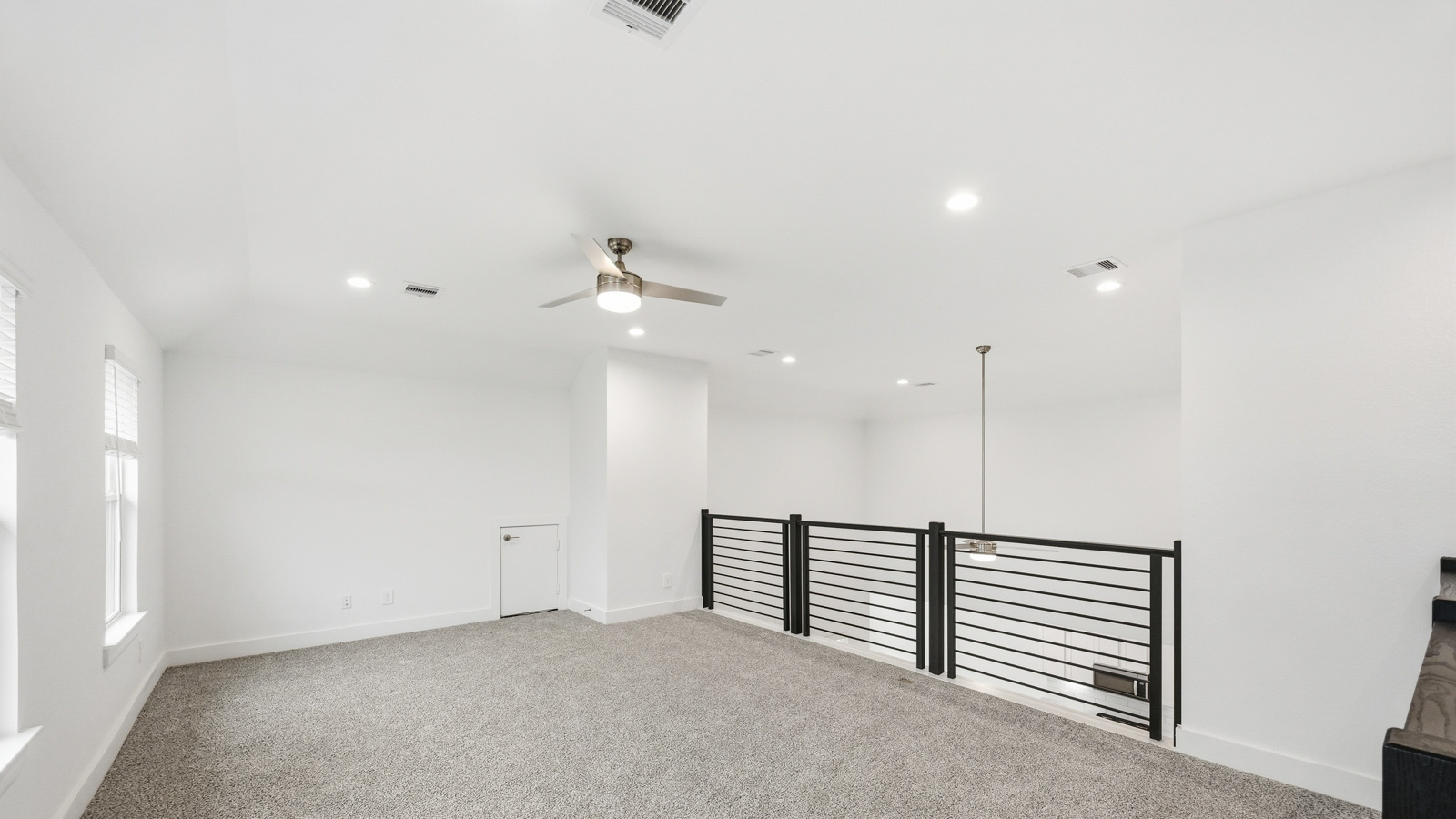 Second story game room with carpet flooring
