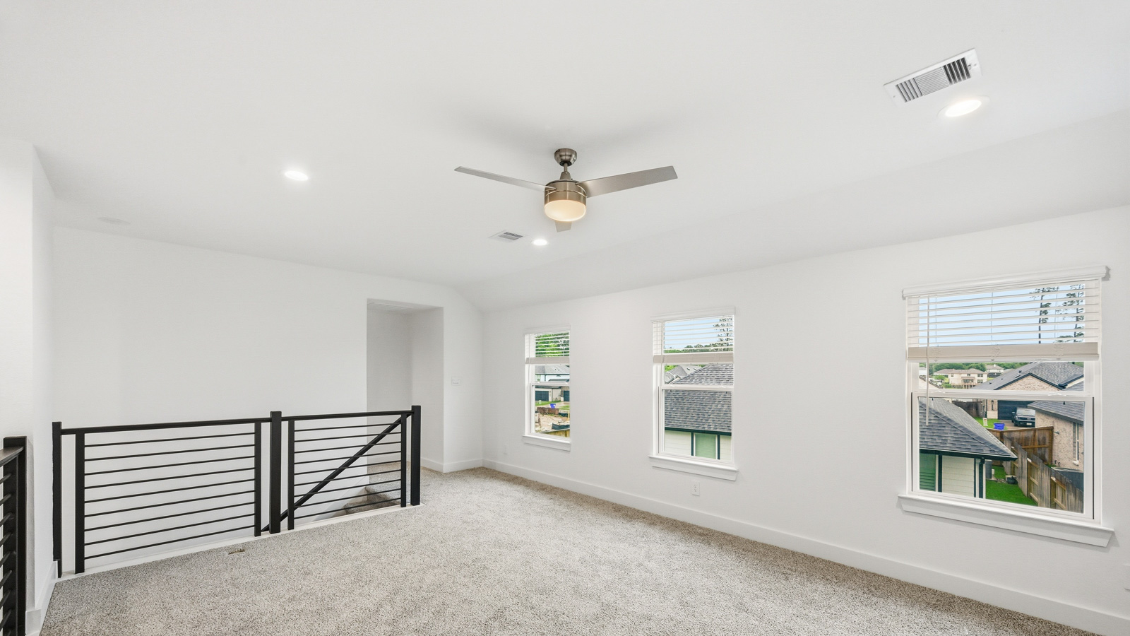 Second story game room with carpet flooring