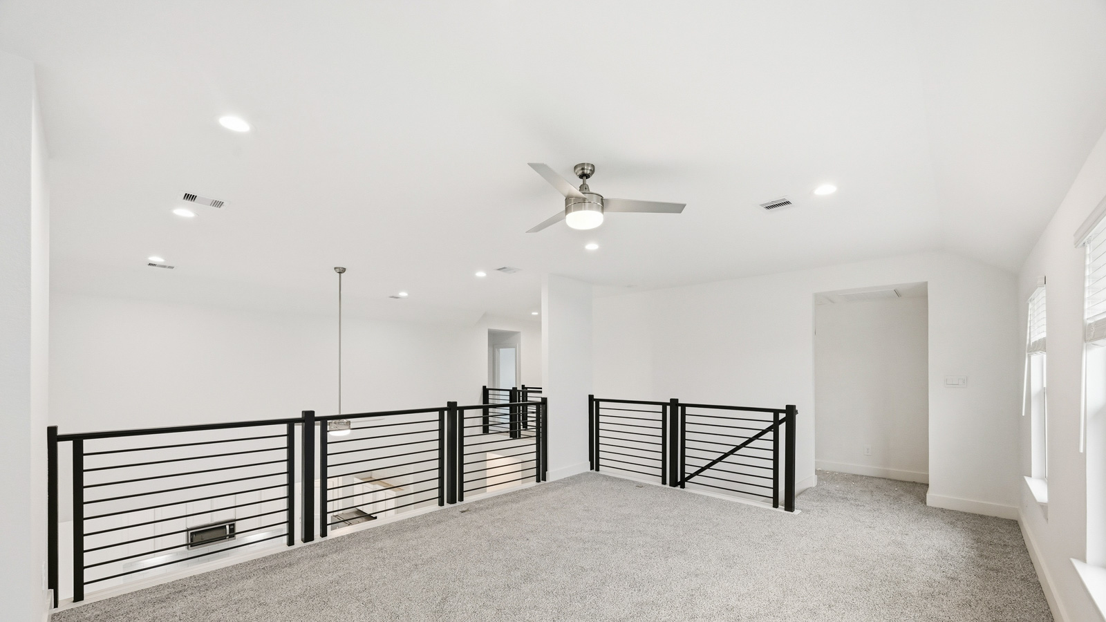 Second story game room with carpet flooring