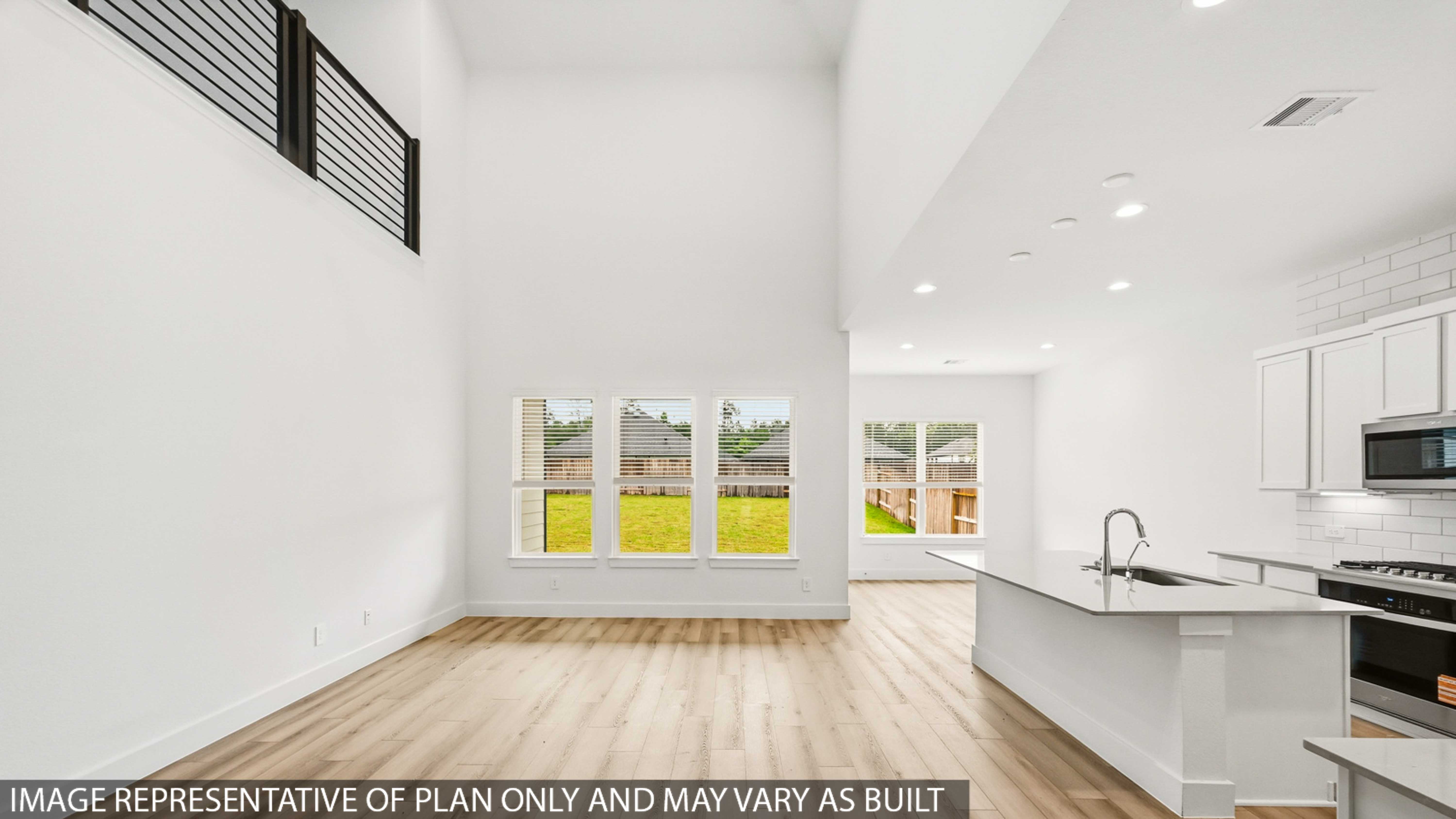 Kitchen with stainless steel appliances, quartz countertops and modern hardware and an island and vinyl floor