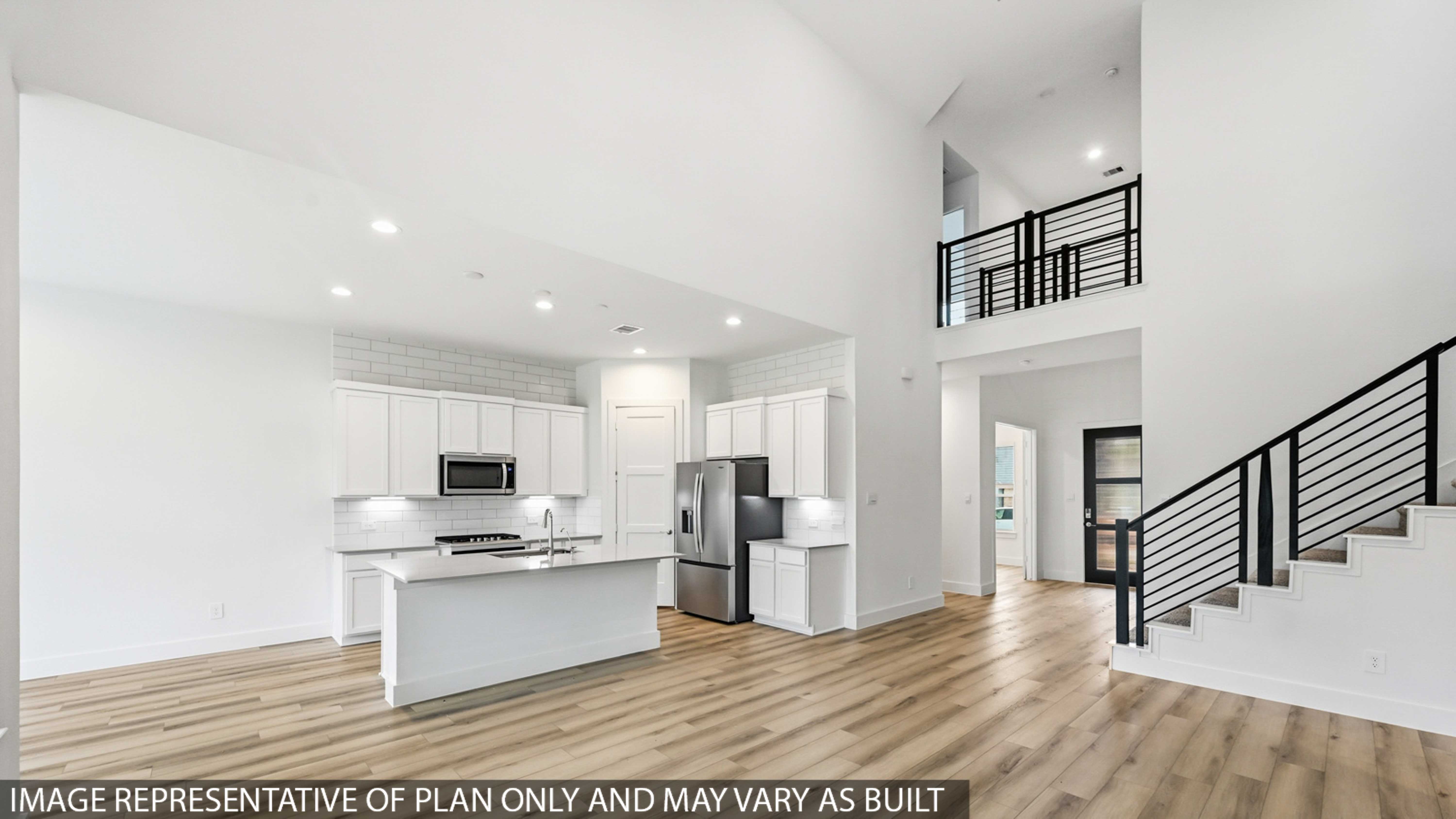 Kitchen with stainless steel appliances, quartz countertops and modern hardware and an island and vinyl floor