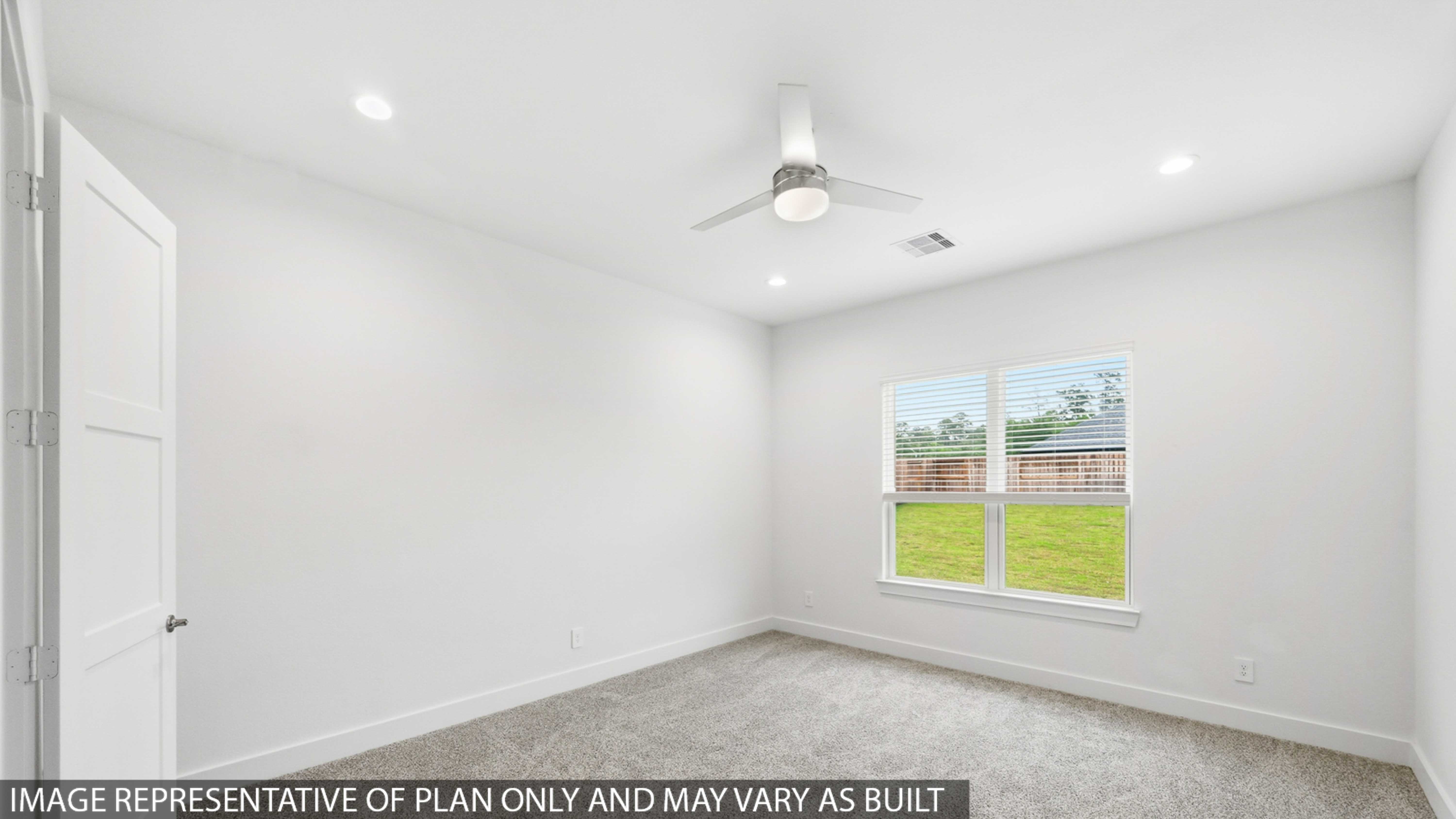 Secondary bedroom with shag carpet flooring and bright window