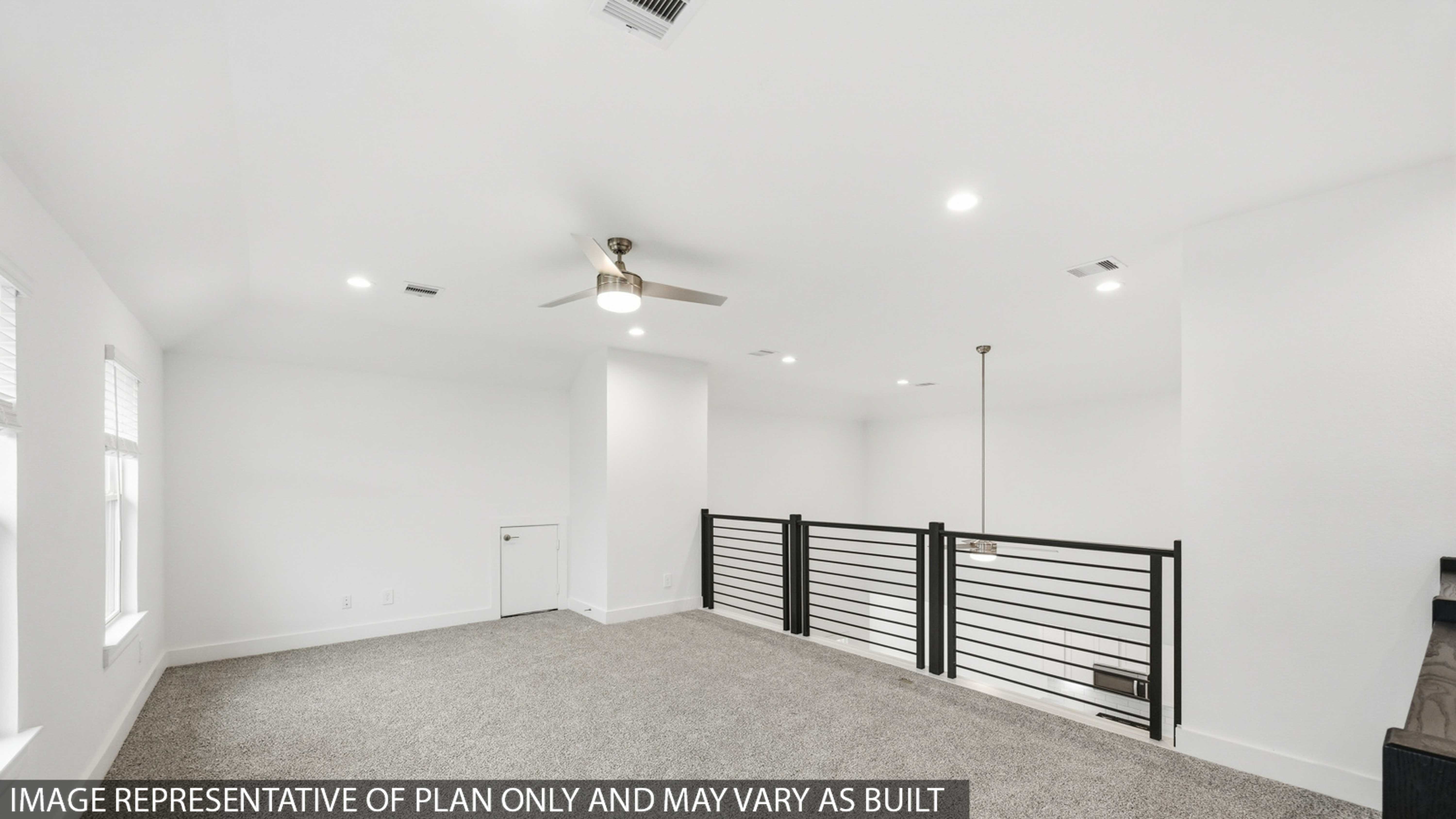 Second story game room with carpet flooring with bright windows in this multi functional space in Montgomery TX