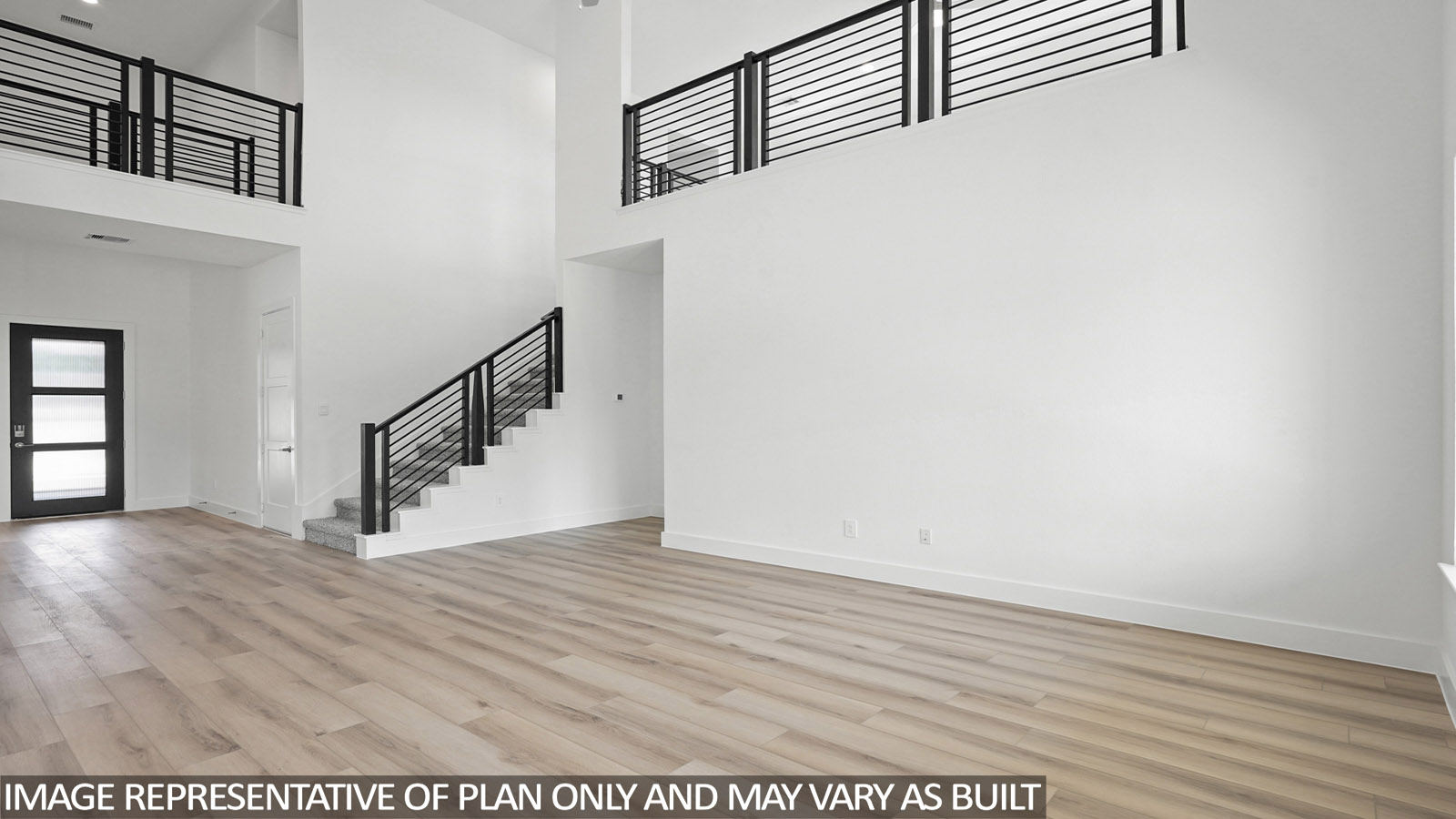 Open living room with windows, white walls, and vinyl wood flooring.