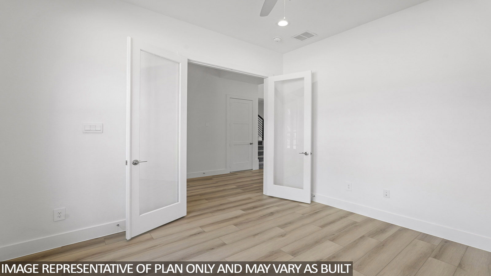 Study with windows, white walls, and vinyl wood flooring.