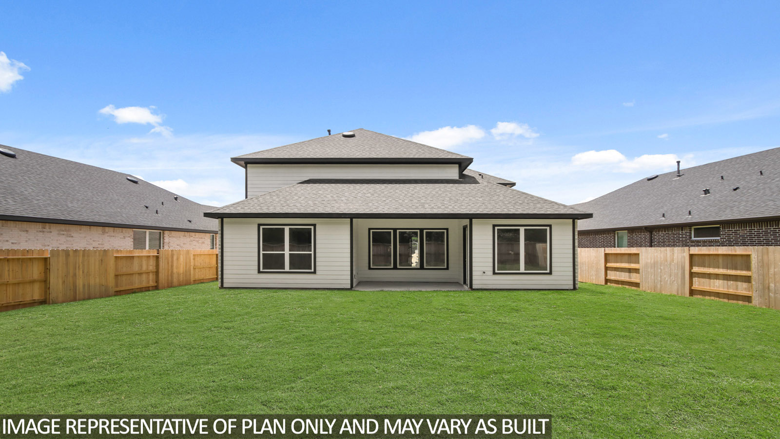 Landscaped backyard with a covered patio.