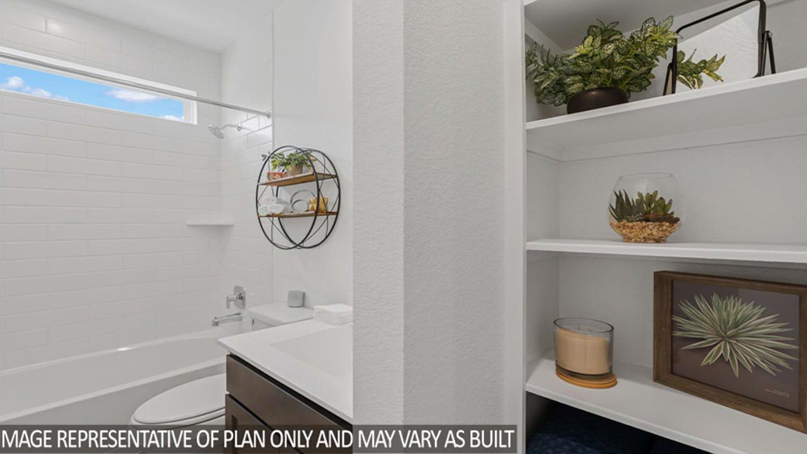 Secondary bathroom with a shower and tub combo, white walls, and vinyl wood flooring.