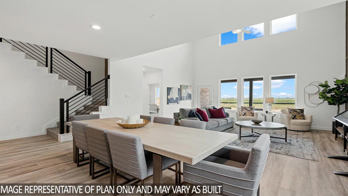 Open living room with windows, white walls, and vinyl wood flooring.