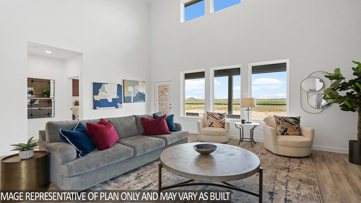 Open living room with windows, white walls, and vinyl wood flooring.