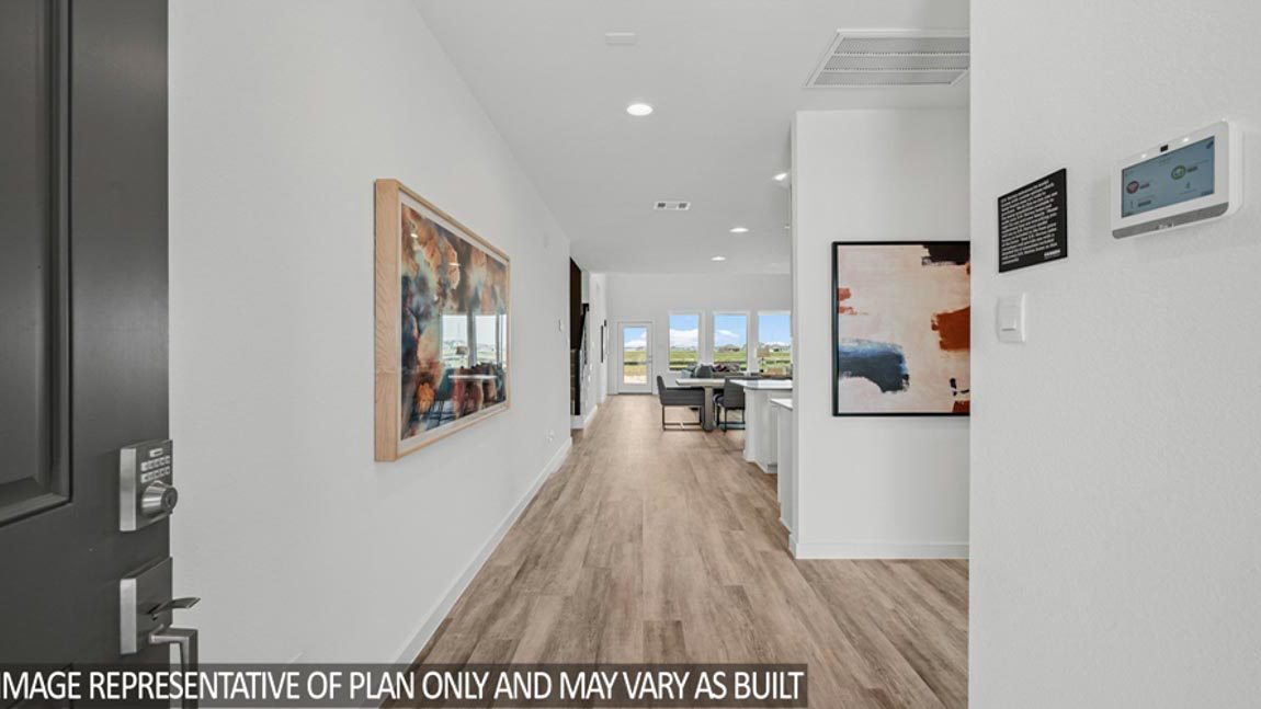 entry hallway with white walls and vinyl wood flooring.