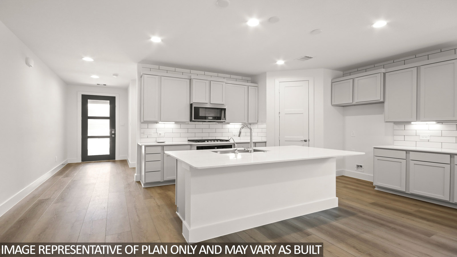 Kitchen with island and stainless-steel appliances.