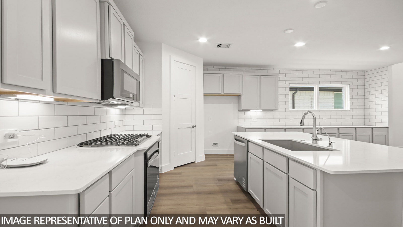 Kitchen with island and stainless-steel appliances.