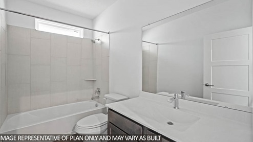 bathroom wth tub and bath surround tile