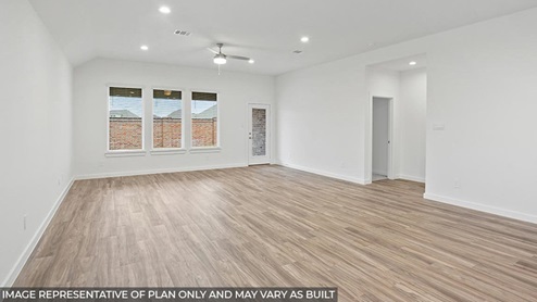 open concept living room and dining with vinyl flooring and large windows