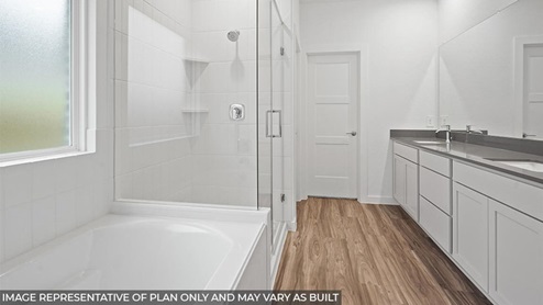 primary bathroom with tub and walk in shower