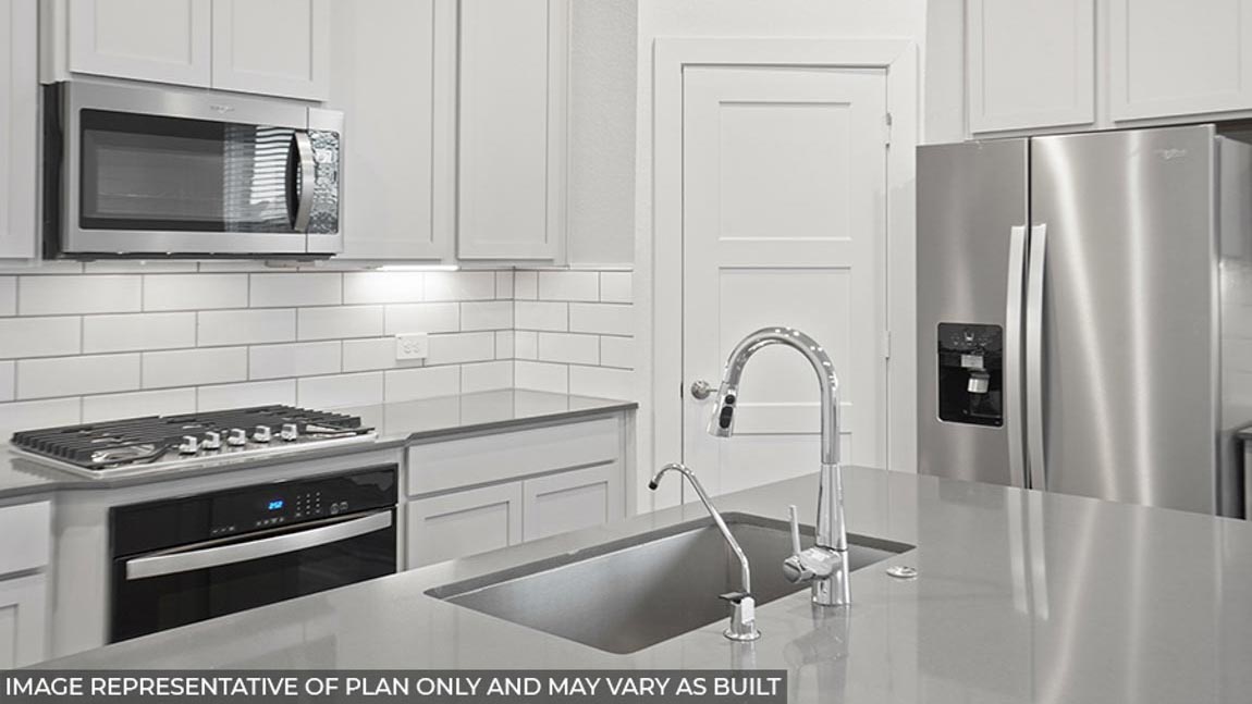 Kitchen with stainless-steel appliances and island.