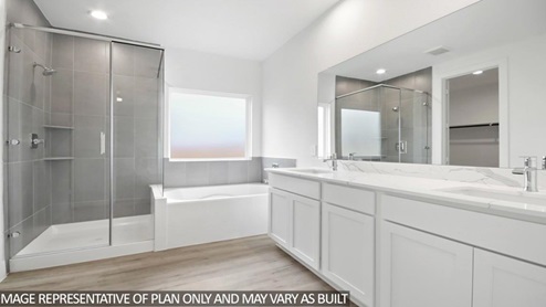 primary bathroom with tub and walk in shower