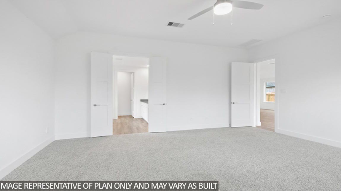 Primary bedroom with two carpet flooring and two-bright windows.