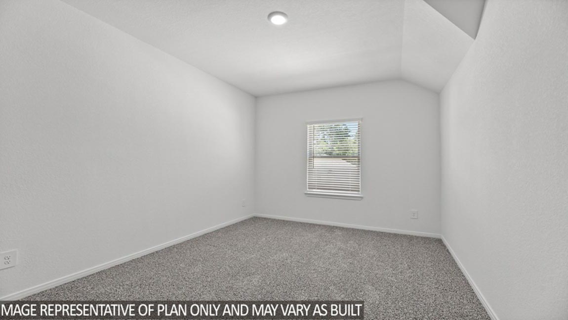 Secondary bedroom with carpet flooring.