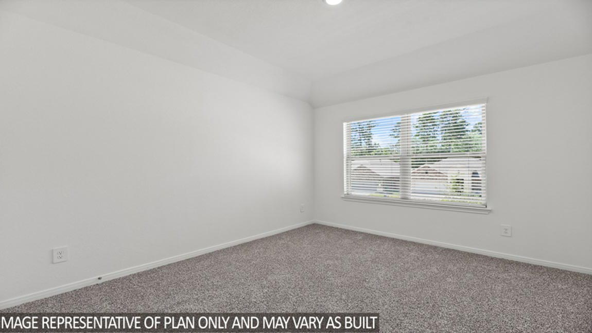 Secondary bedroom with carpet flooring.